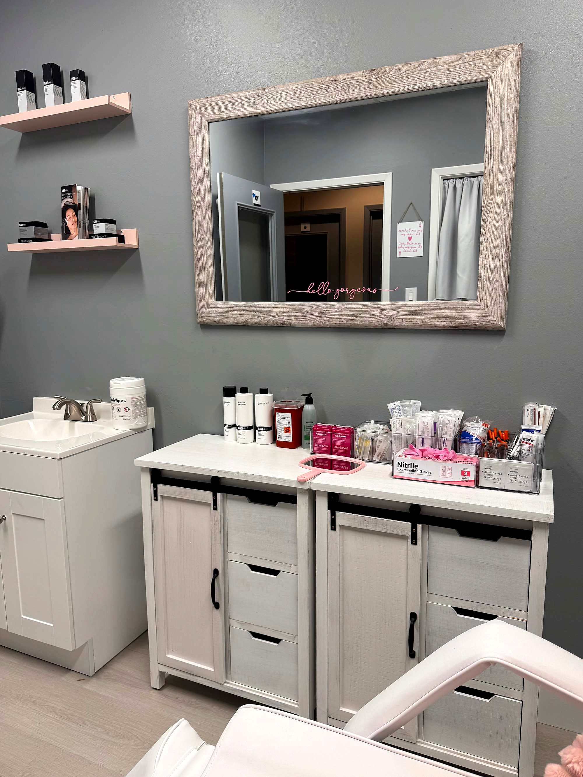 White vanity and mirror with skincare on the shelves