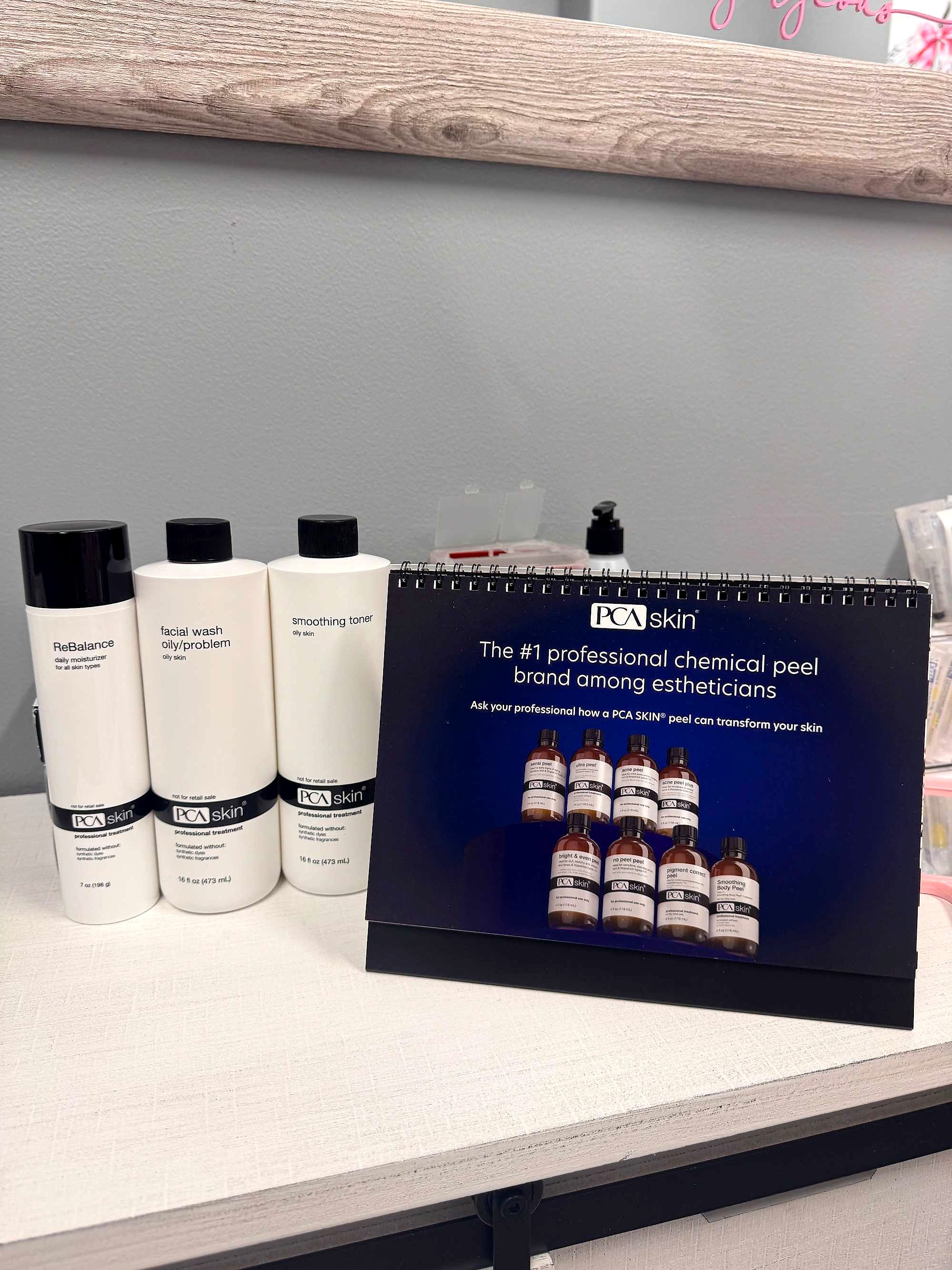PCA SKIN bottles beside a desk card naming it the number one professional chemical peel brand