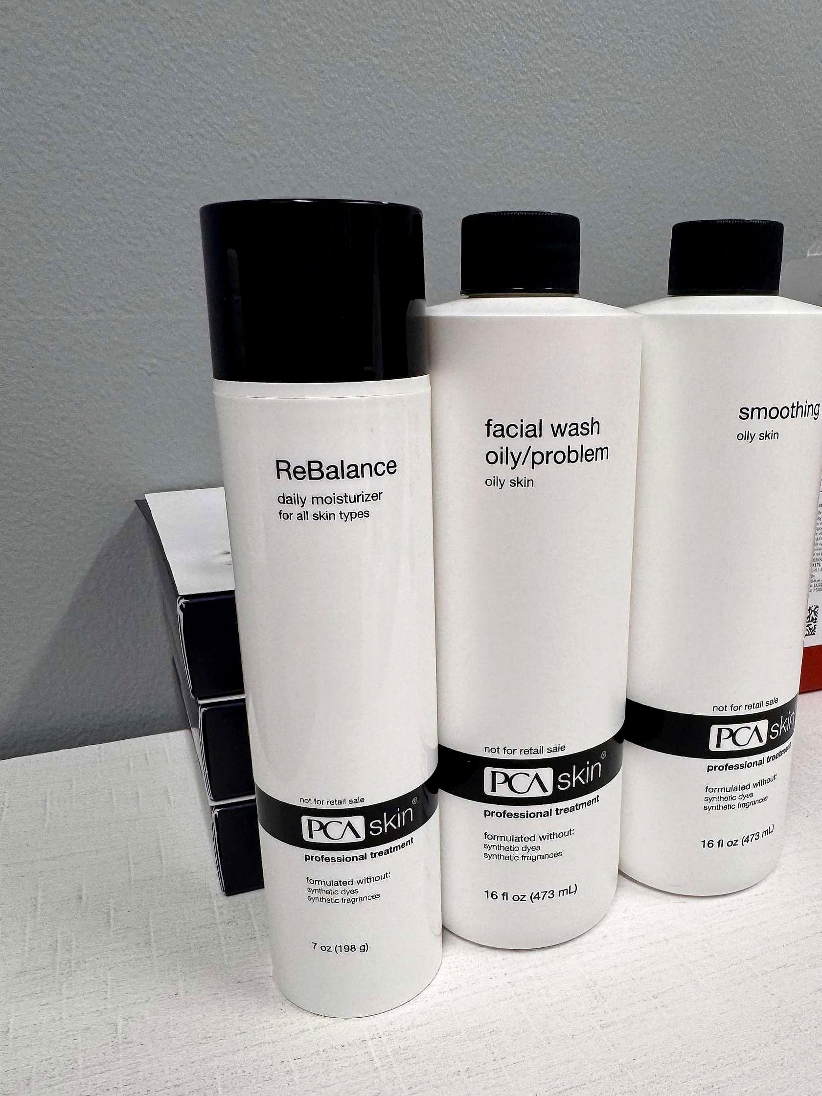 PCA SKIN cleanser and toner bottles in the suite